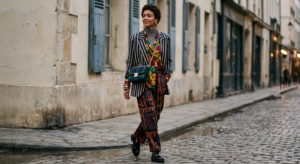 Stylish fashion editorial featuring a confident woman layering bold, clashing patterns like stripes