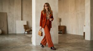 A high-fashion editorial shot of a stylish woman wearing a modern outfit with distinct 1970s retro-i