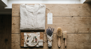 A professional, editorial-style flat lay featuring a neatly folded vintage garment next to natural l